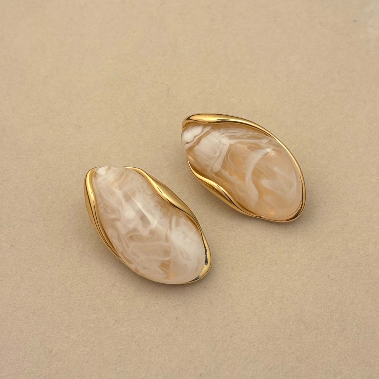 White marble-effect resin oval earrings with gold-toned rims, two-piece set