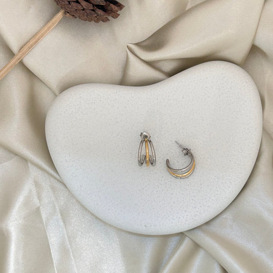 Bi metal triple hoop earrings with stacked silver and gold rings, front view