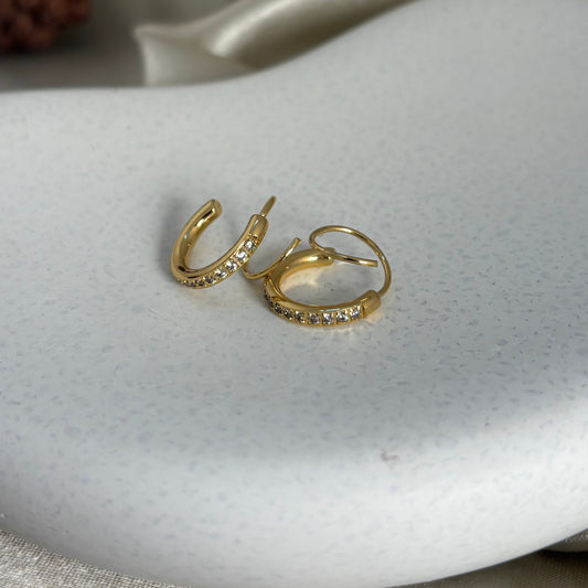 Gold-tone double helix illusion hoop earrings with clear rhinestones