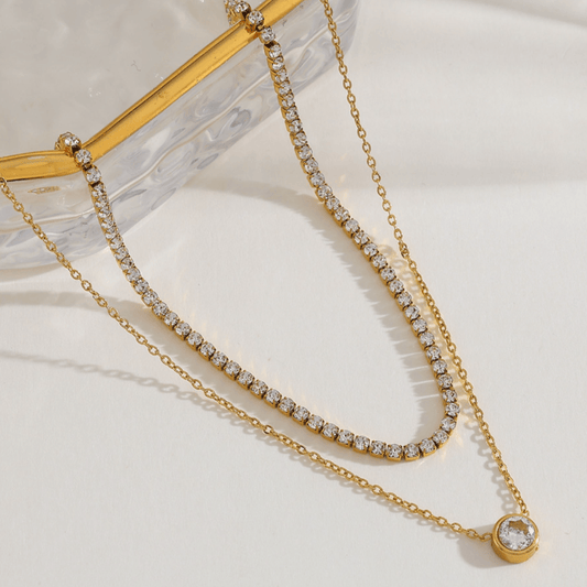 Gold layered tennis necklace with sparkling pavé links and round pendant charm