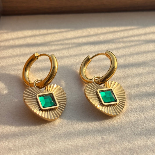 Gold hoop earrings with heart pendant and green square gemstone detail