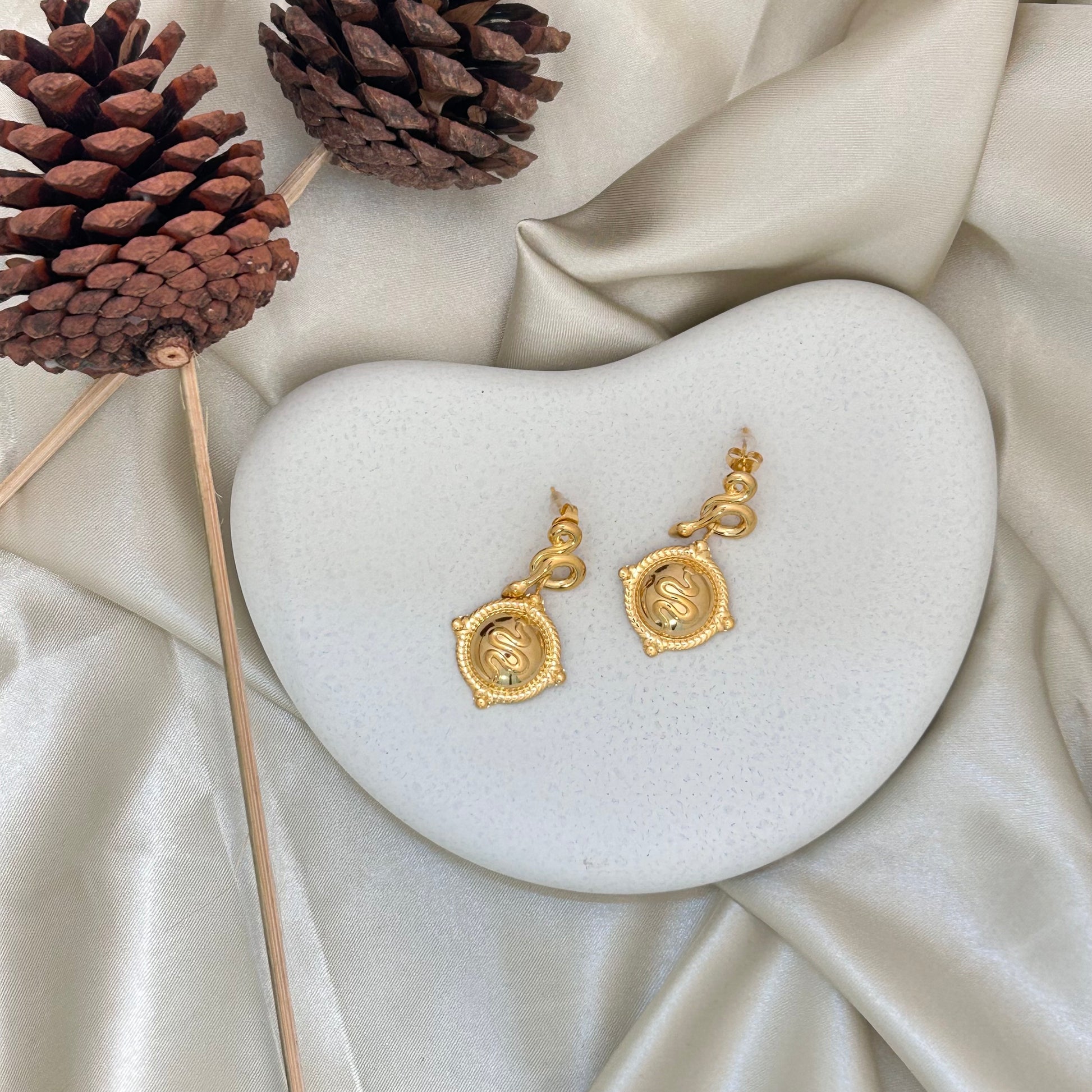 Pair of gold-tone square pendant earrings with engraved swirl motif