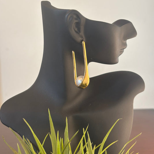 Gold-tone hoop earrings with white pearl set in curved frame