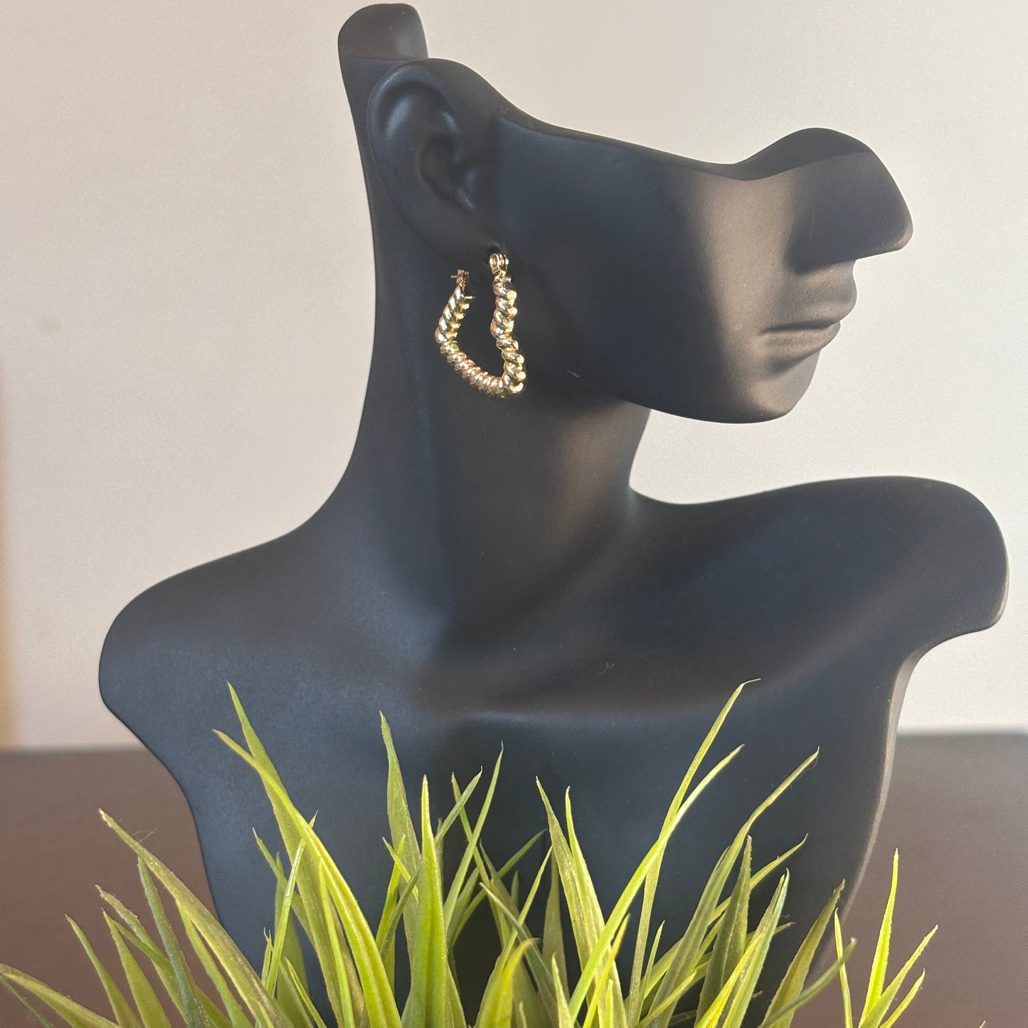 Gold-tone heart wrap hoop earrings with textured heart shape, side view on mannequin