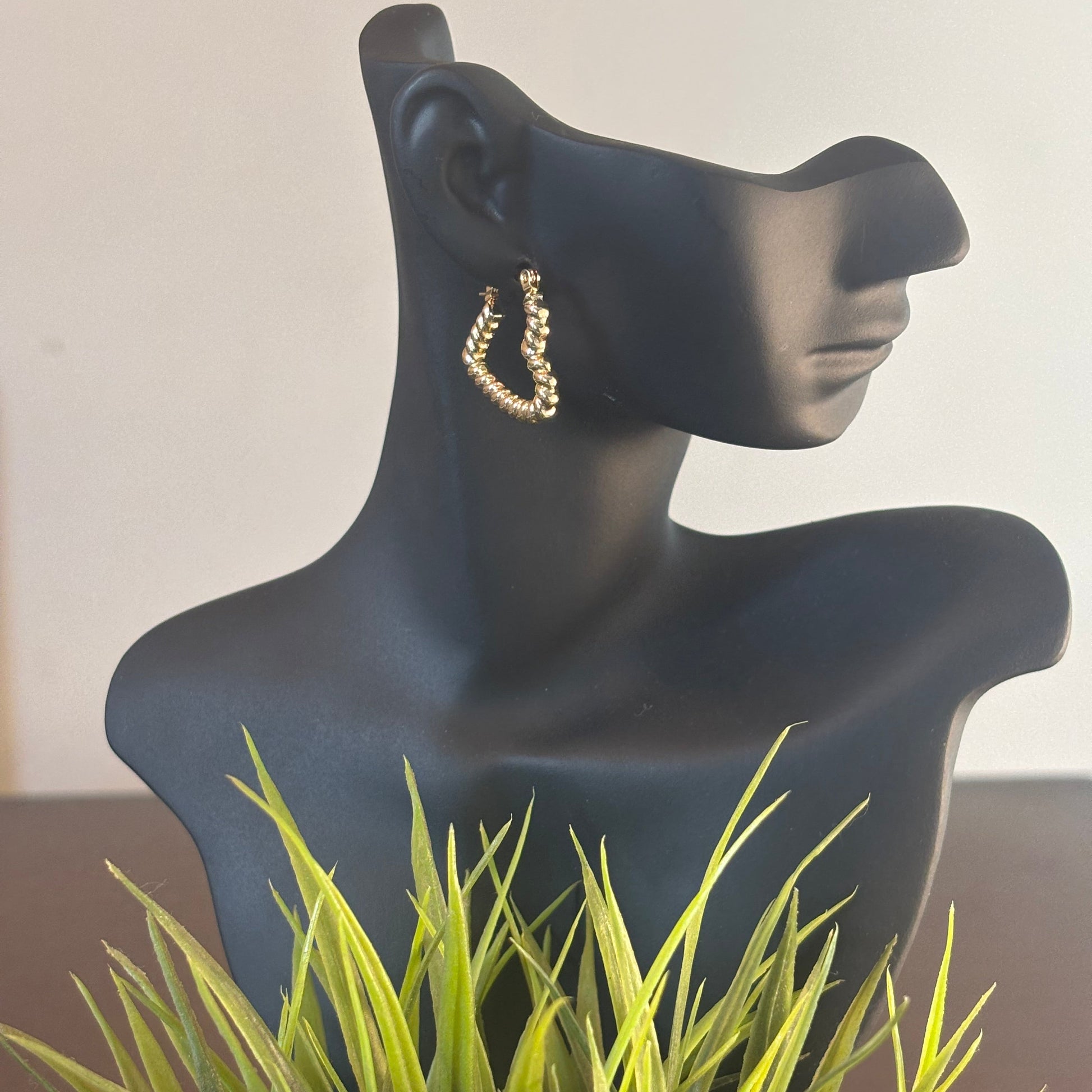 Gold-tone heart wrap hoop earrings with textured heart shape, side view on mannequin