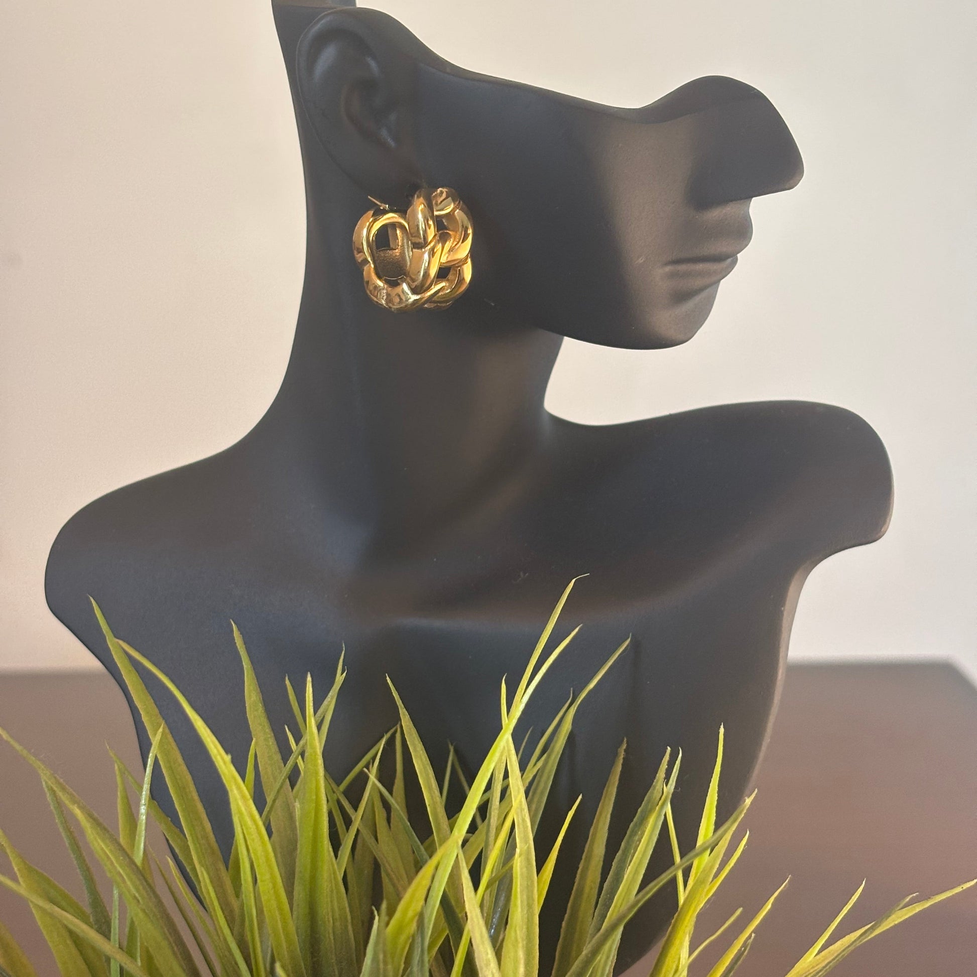 Chunky gold hoop earrings with interlocking textured rings