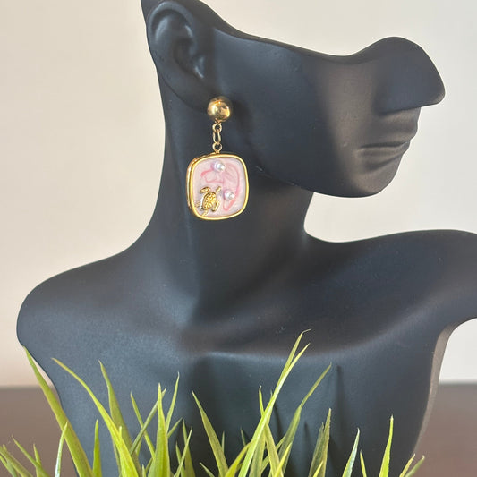 Gold hoop dangle earrings with square pink turtle charm and pink pearl detail