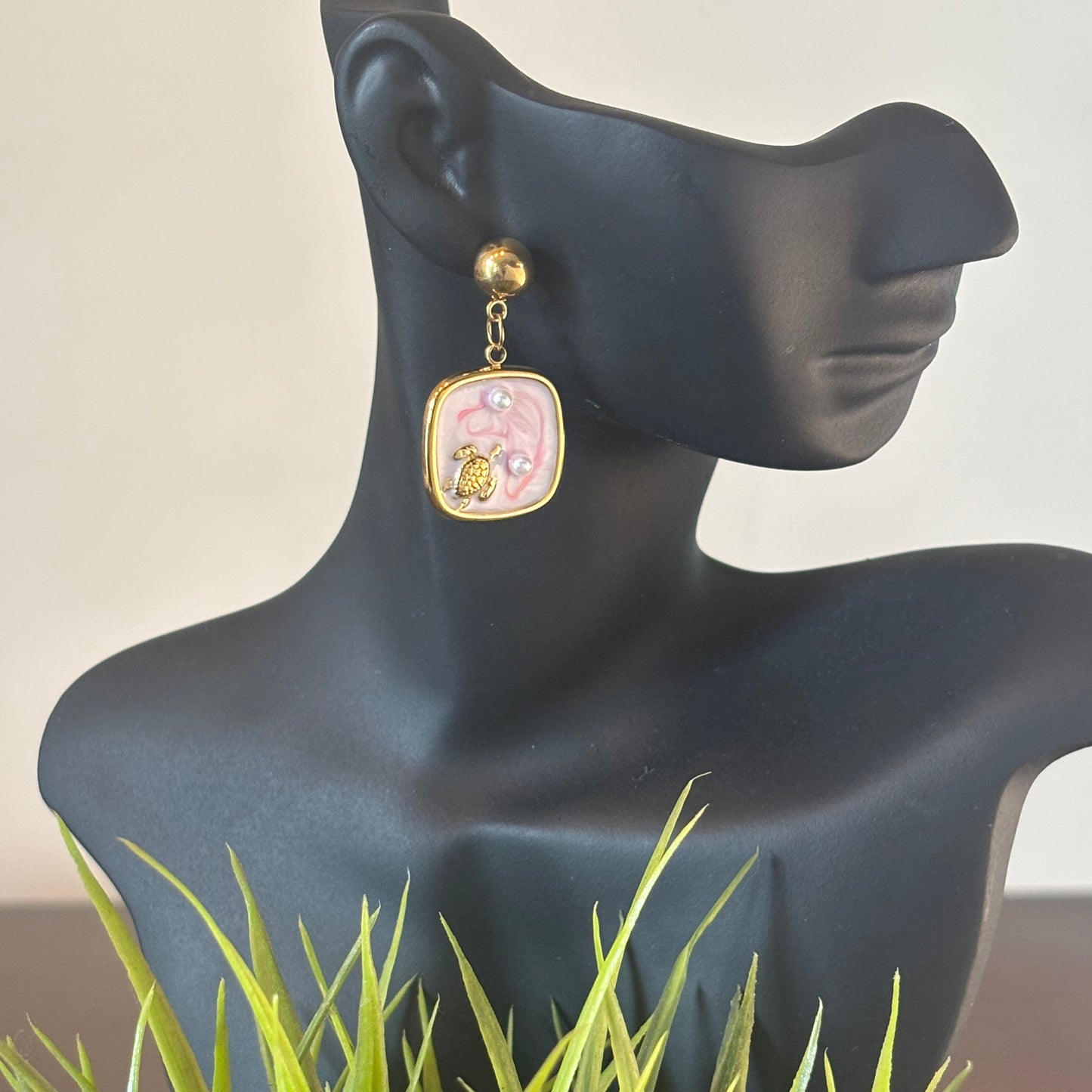 Gold hoop dangle earrings with square pink turtle charm and pearl drop detail