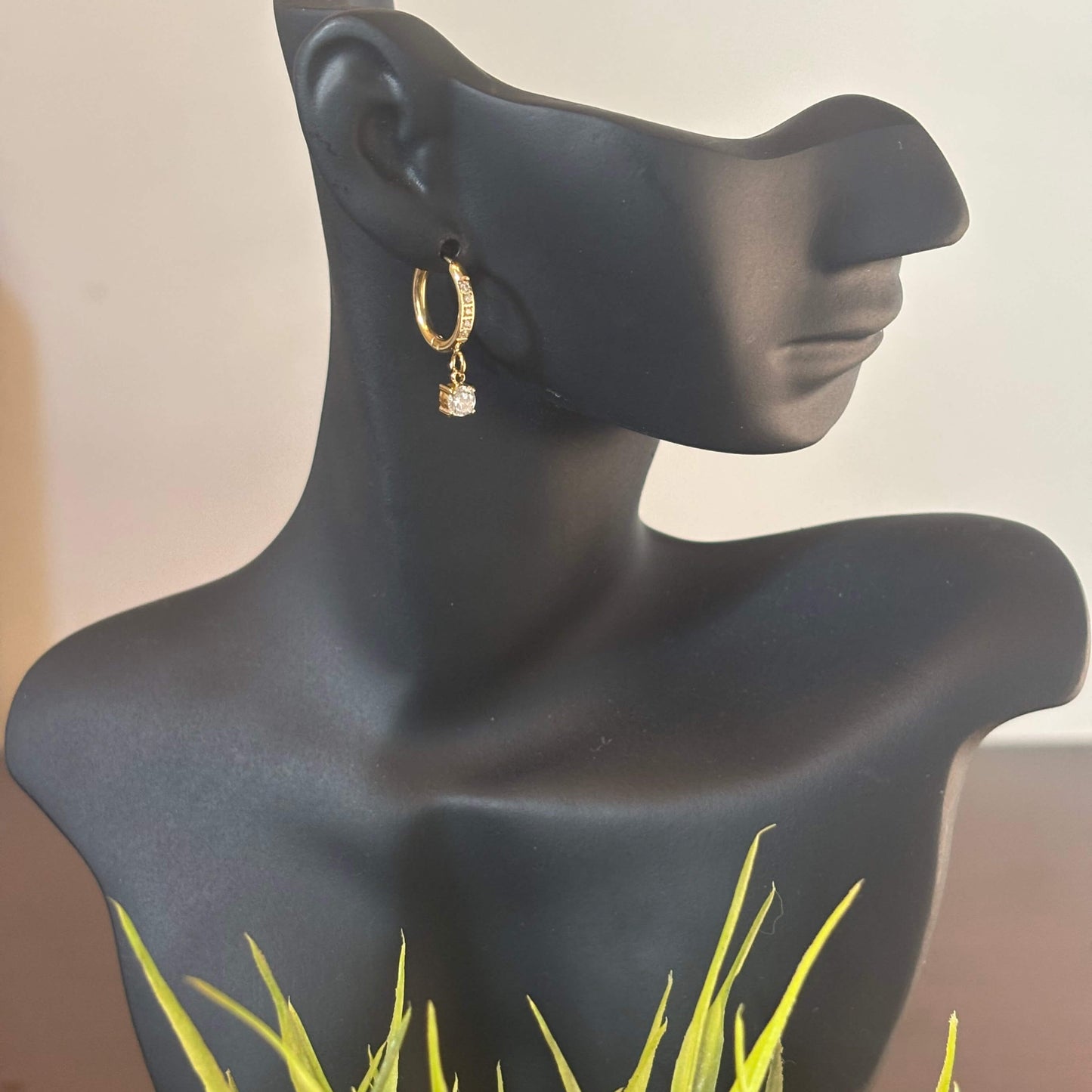 Gold hoop drop earring with small crystal charm on hook