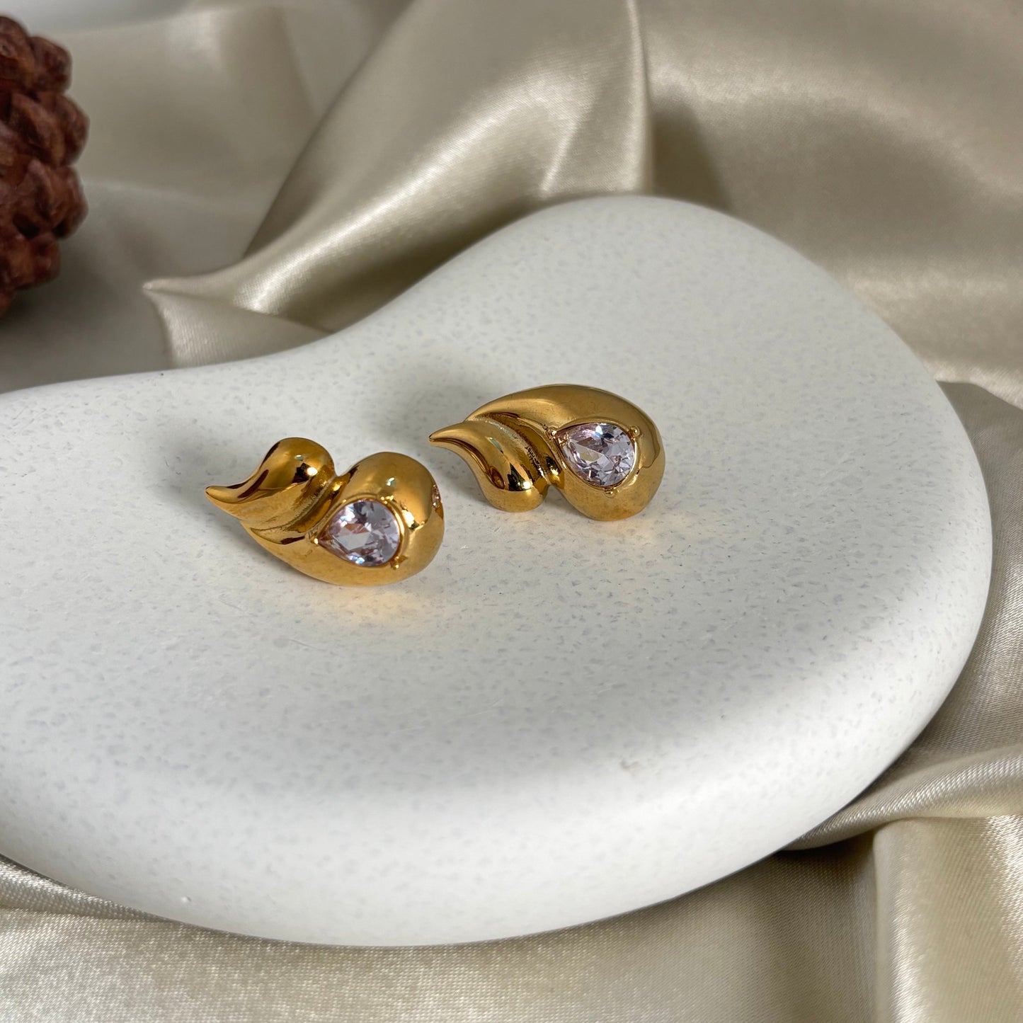 Gold teardrop earrings with clear crystal studs, curved hoop style