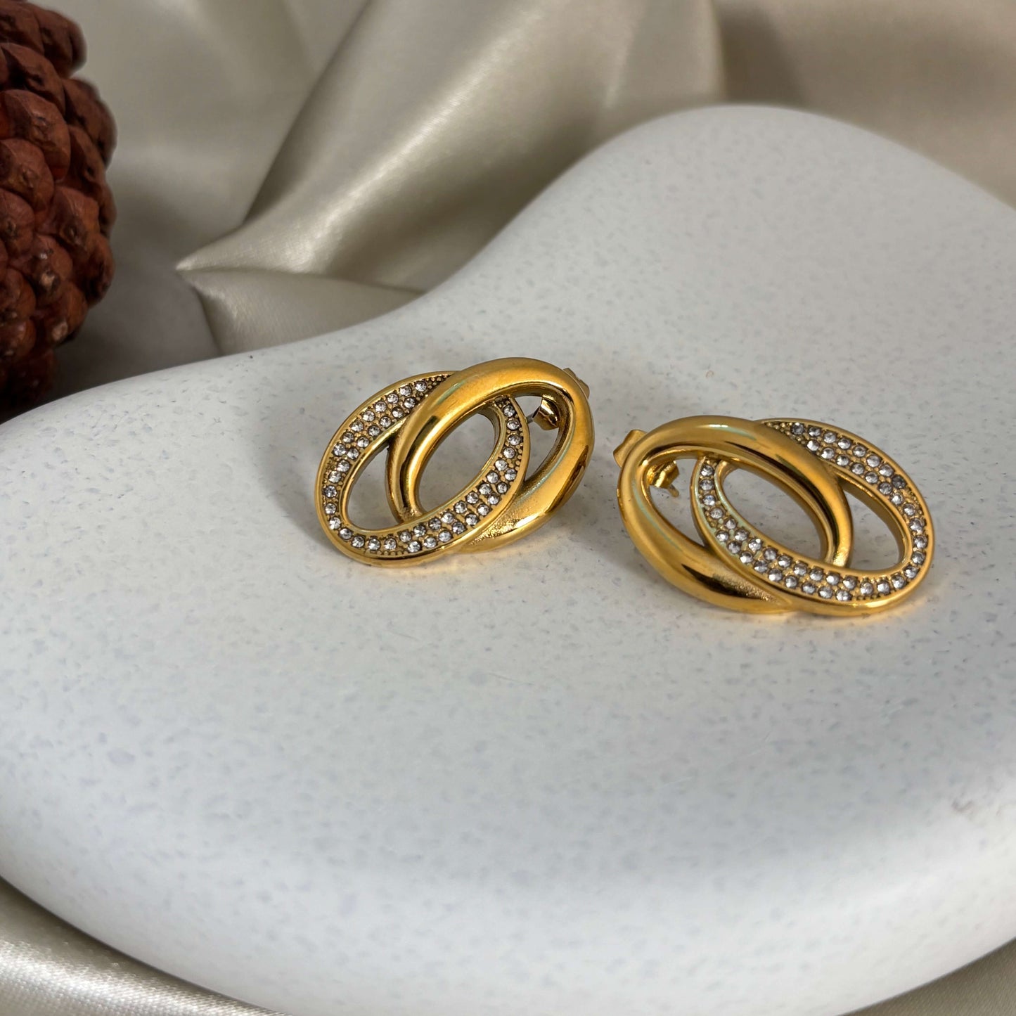 Gold-tone linked loop hoop earrings with rhinestone pavé surround