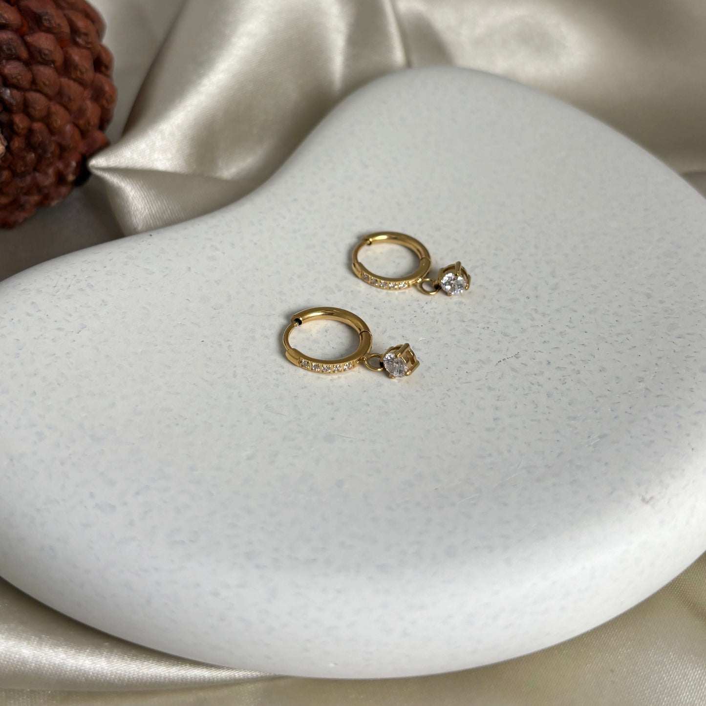 Gold hoop drop earrings with crystal accent, shown as a pair