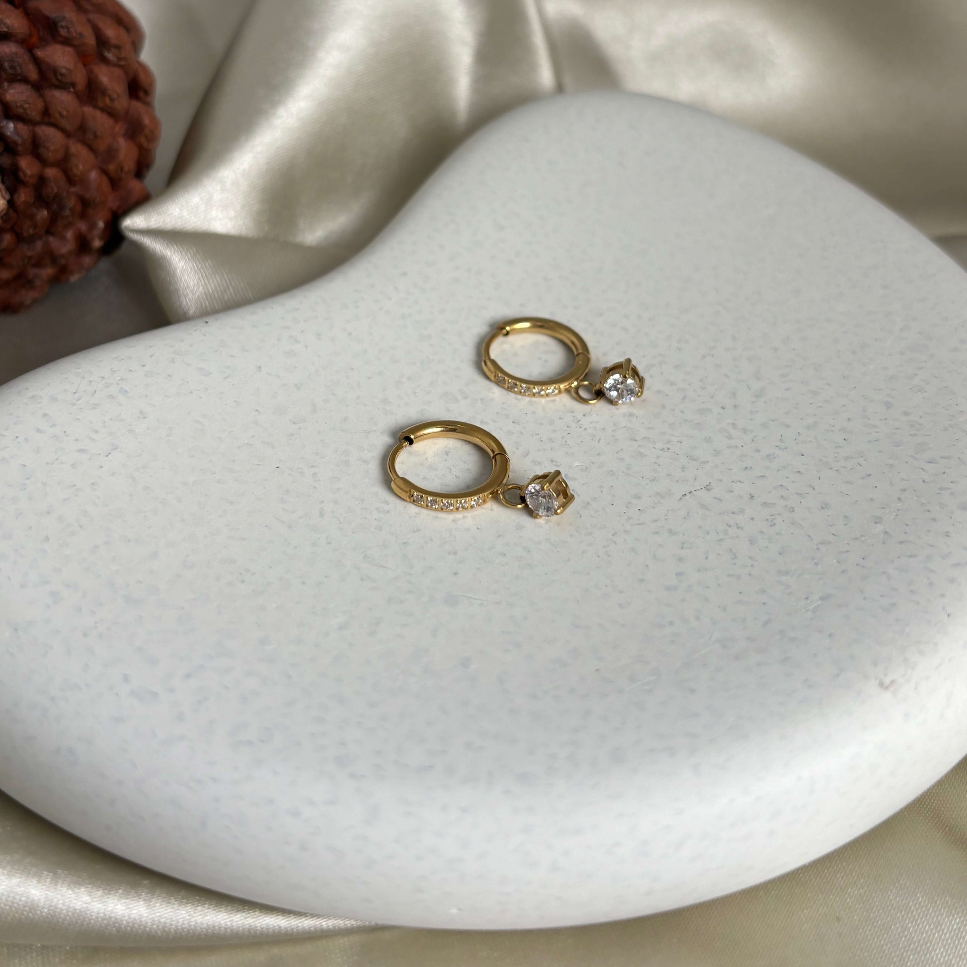 Gold hoop drop earrings with crystal accent, shown as a pair