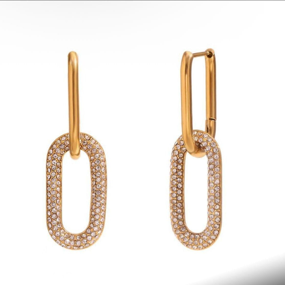 Gold-tone oval hoop earrings with full rhinestone border and smooth top posts