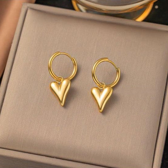 Striking heart drop earrings with gold-tone heart dangles and small hoop hooks